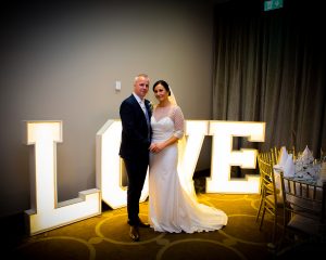 Fiona & Jonathan posing with love letters