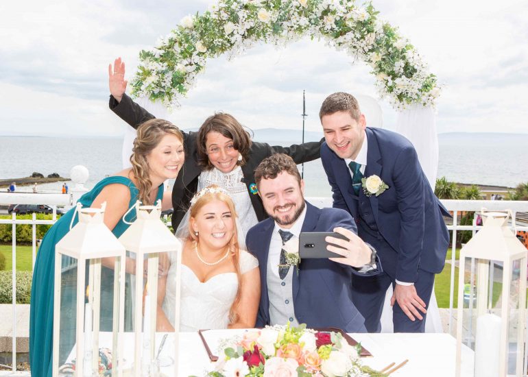 bride and groom taking a selfie with celebrant and witnesses