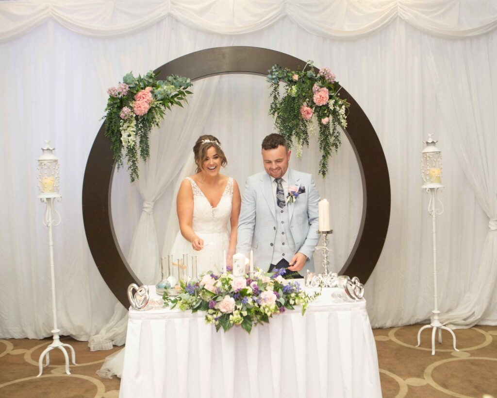 bride and groom lighting candles as part of the ceremony