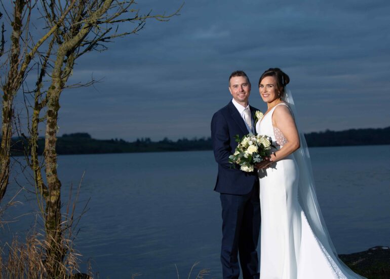 Bride and groom enjoying a relaxed lakeside wedding portrait