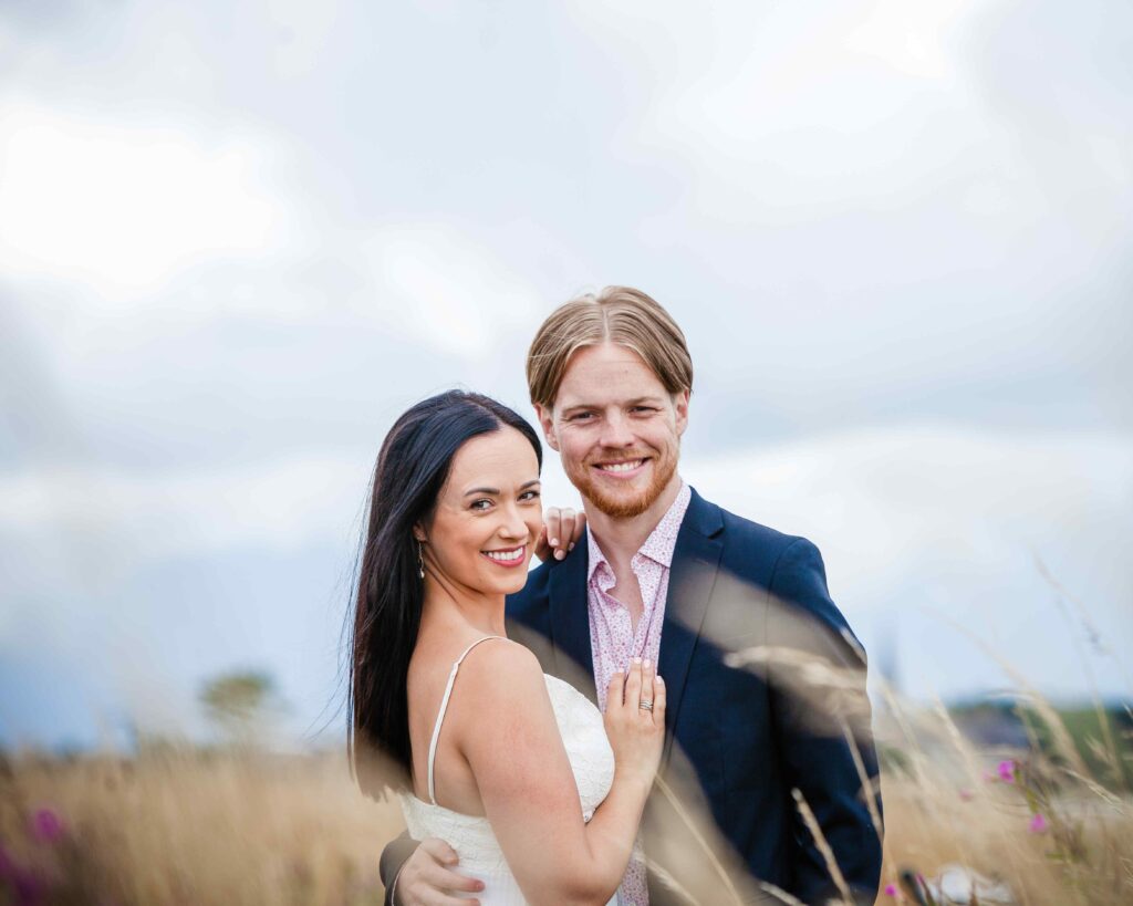 couple posing in the long grass in Corrys field Loughrea