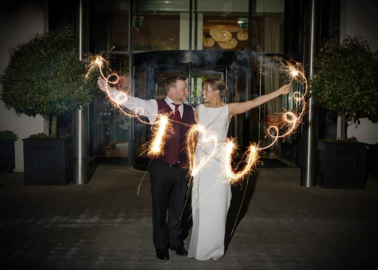 bride and groom holding sparklers