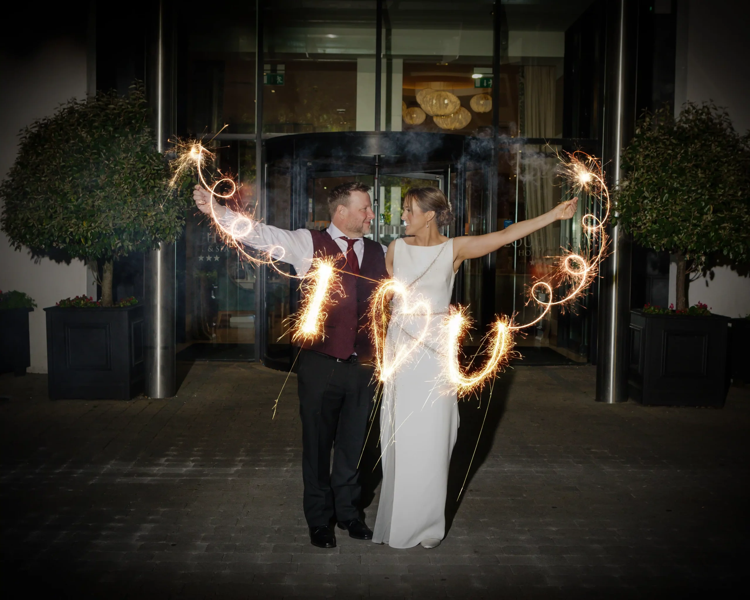 bride and groom holding sparklers