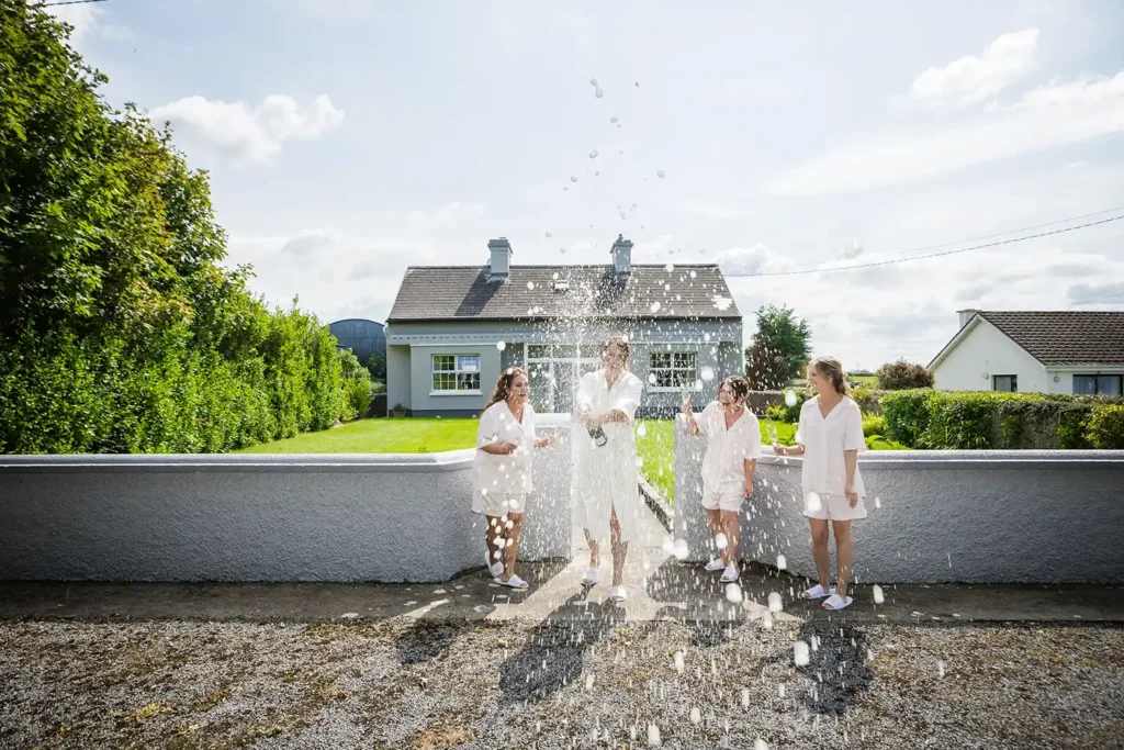 Champagne spray outside the brides house before she sets off for the Ardilaun Hotel Galway