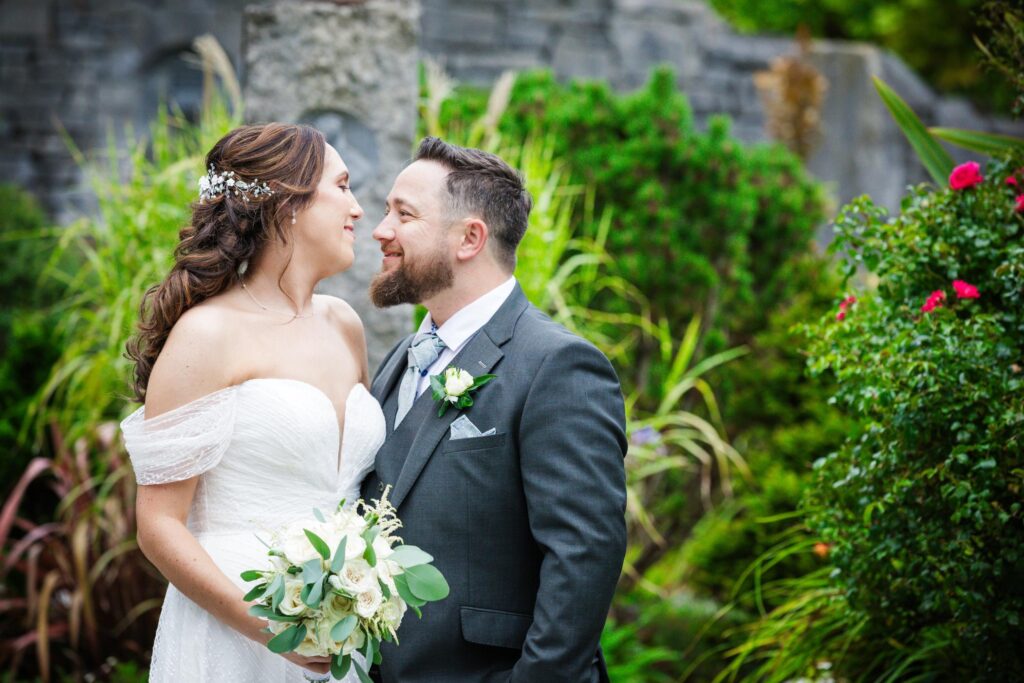 Denise and Gareth smiling together among the garden flowers