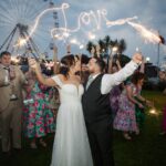 Newlyweds celebrating with guests and sparklers outside Galway Bay Hotel