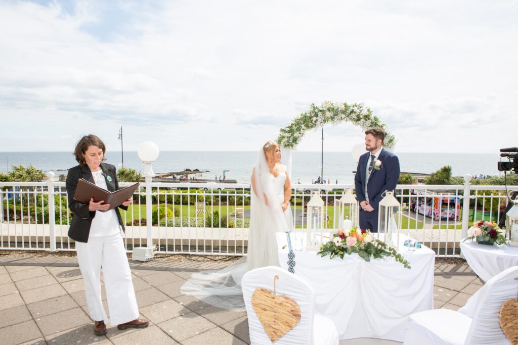 Bride and groom during an outdoor wedding ceremony overlooking Galway Bay