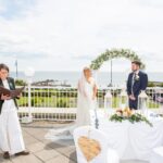 Bride and groom during an outdoor wedding ceremony overlooking Galway Bay
